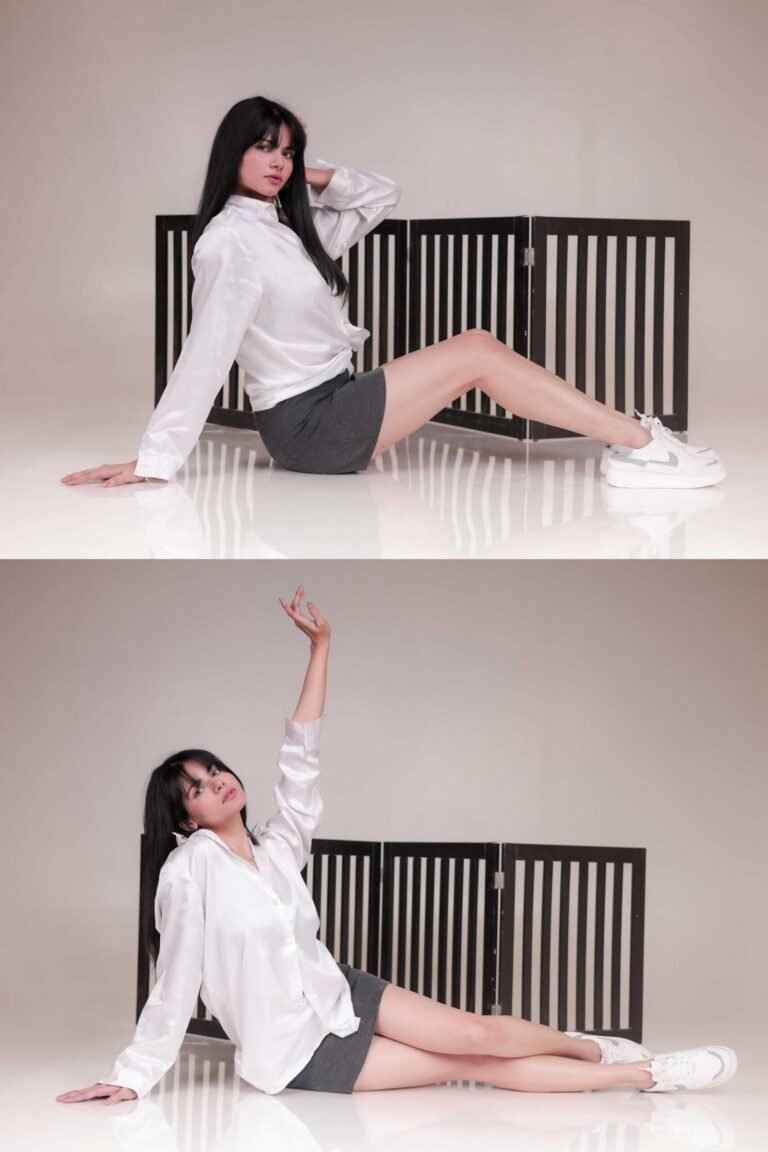 Studio fashion poses captured at Lens Grove Studio, a professional photo and video shoot rental space in Delhi, featuring a female model in a white shirt, grey shorts, and sneakers, seated and reclining on a glossy studio floor with black slatted panel backdrops, styled for editorial and portfolio photography.