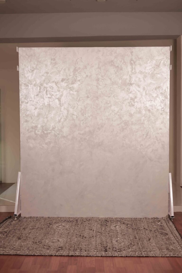 Neutral textured photography backdrop at Lens Grove Studio, a professional photo and video shoot rental space in Delhi, featuring a soft-toned abstract wall panel mounted on stands, suitable for fashion, product, and portrait photography.