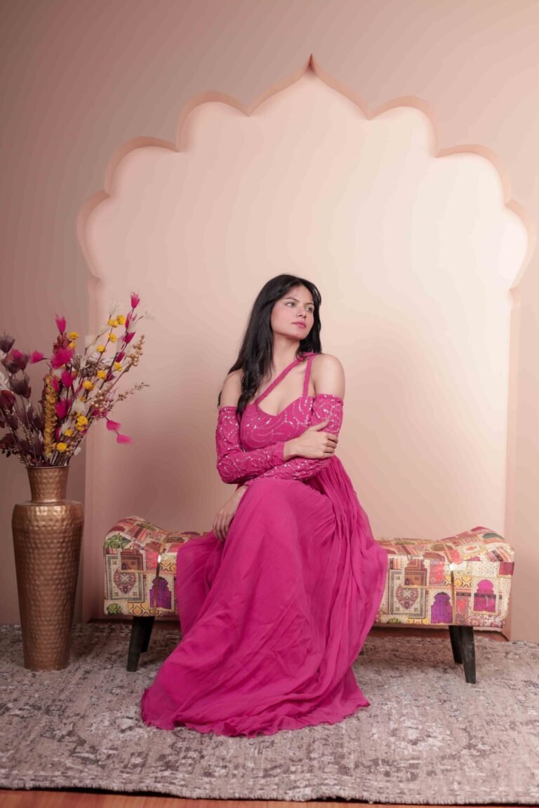 Fashion portrait shot at Lens Grove Studio, a professional photo and video shoot rental space in Delhi, featuring a female model in a pink gown posing within an arched backdrop, styled with soft studio lighting for editorial, fashion, and portfolio photography.