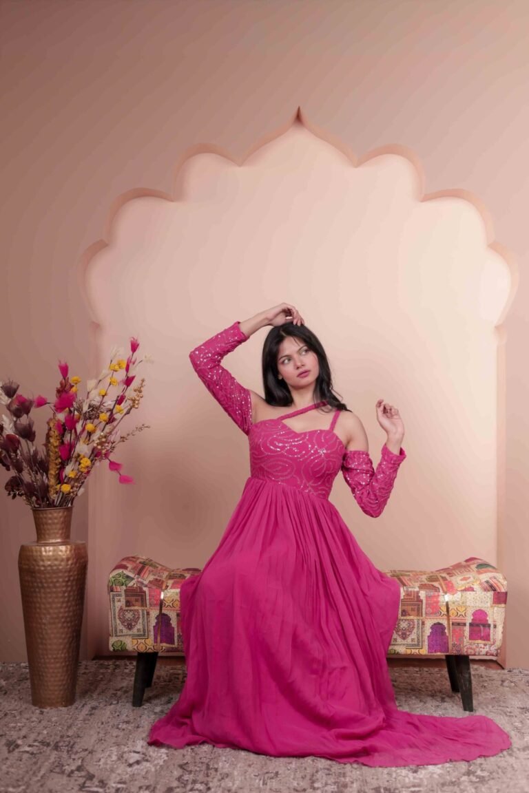 Fashion portrait shot at Lens Grove Studio, a professional photo and video shoot rental space in Delhi, featuring a female model in a pink gown posing within an arched backdrop, styled with soft studio lighting for editorial, fashion, and portfolio photography.