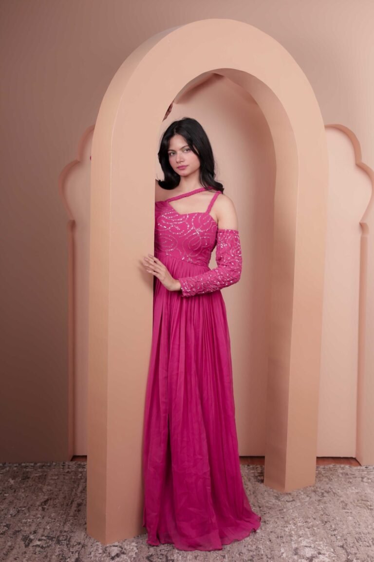 Fashion portrait shot at Lens Grove Studio, a professional photo and video shoot rental space in Delhi, featuring a female model in a pink gown posing within an arched backdrop, styled with soft studio lighting for editorial, fashion, and portfolio photography.