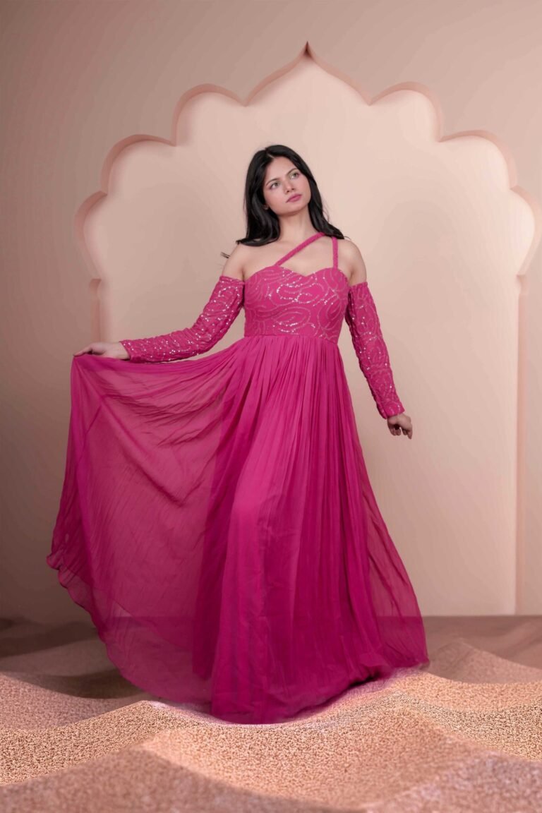 Fashion portrait shot at Lens Grove Studio, a professional photo and video shoot rental space in Delhi, featuring a female model in a pink gown posing within an arched backdrop, styled with soft studio lighting for editorial, fashion, and portfolio photography.