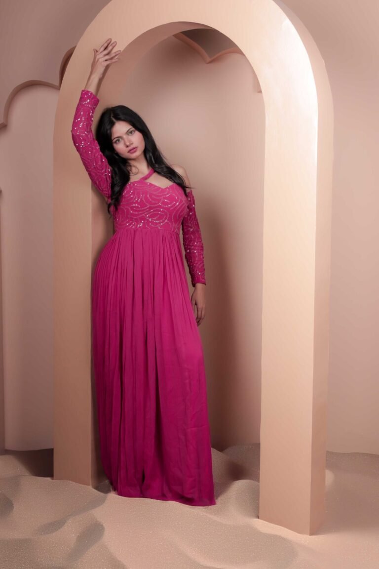 Fashion portrait shot at Lens Grove Studio, a professional photo and video shoot rental space in Delhi, featuring a female model in a pink gown posing within an arched backdrop, styled with soft studio lighting for editorial, fashion, and portfolio photography.