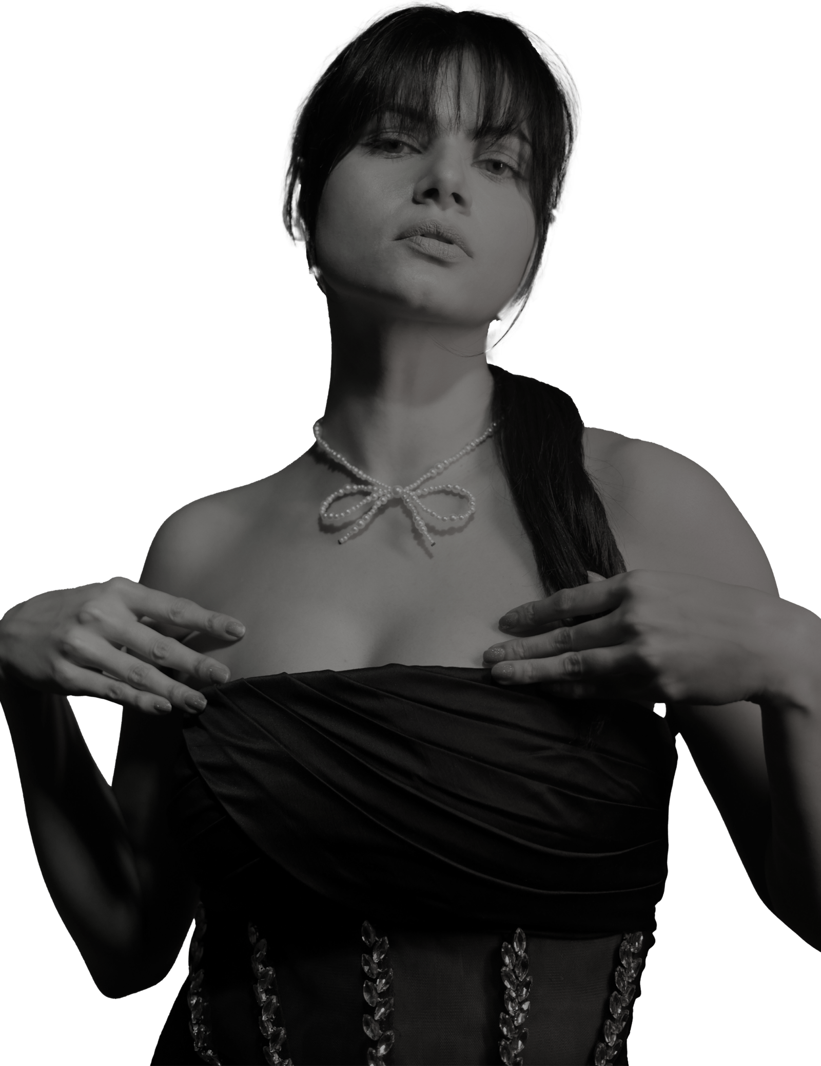 Black-and-white fashion portrait shot at Lens Grove Studio, a professional photo and video shoot rental space in Delhi, featuring a female model in an elegant strapless outfit with a statement bow necklace, styled against a transparent background for editorial, portfolio, and creative design use.